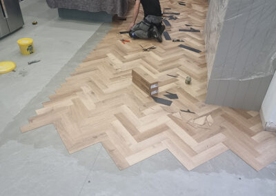 Flooring fitter preparing floor for tiles