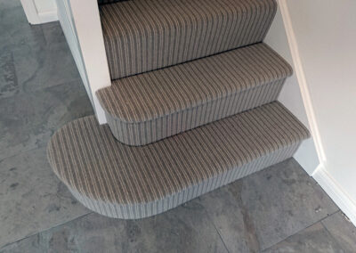 Lovely stripped carpet on the bottom of the stair with stunning ceramic tiles